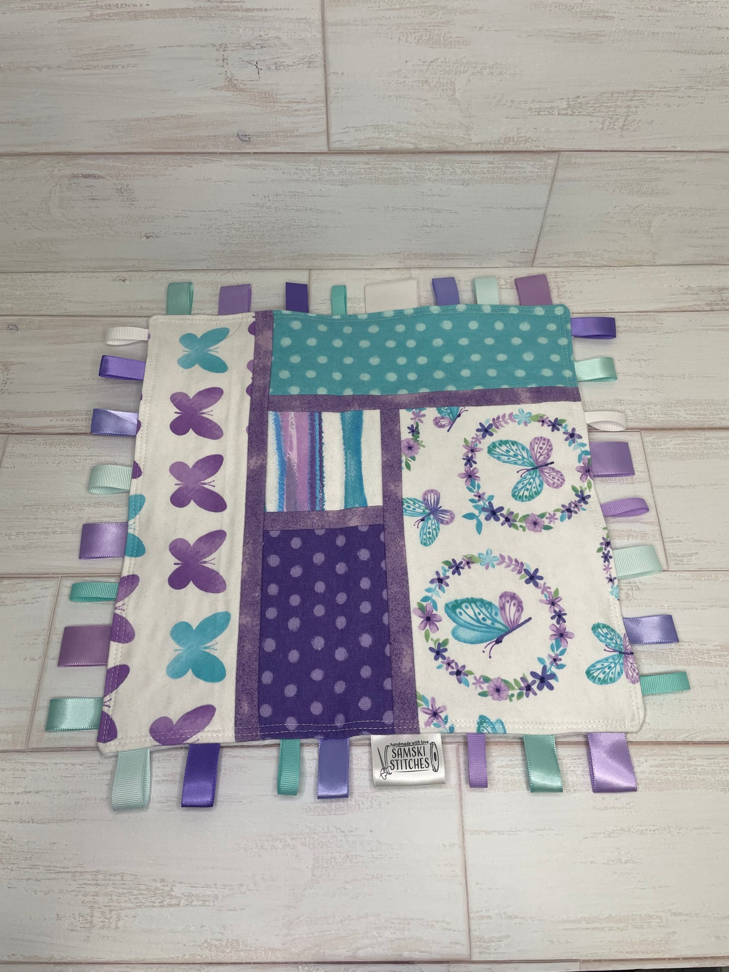 Butterflies on White with Turquoise and Purple Accents Sensory Taglet