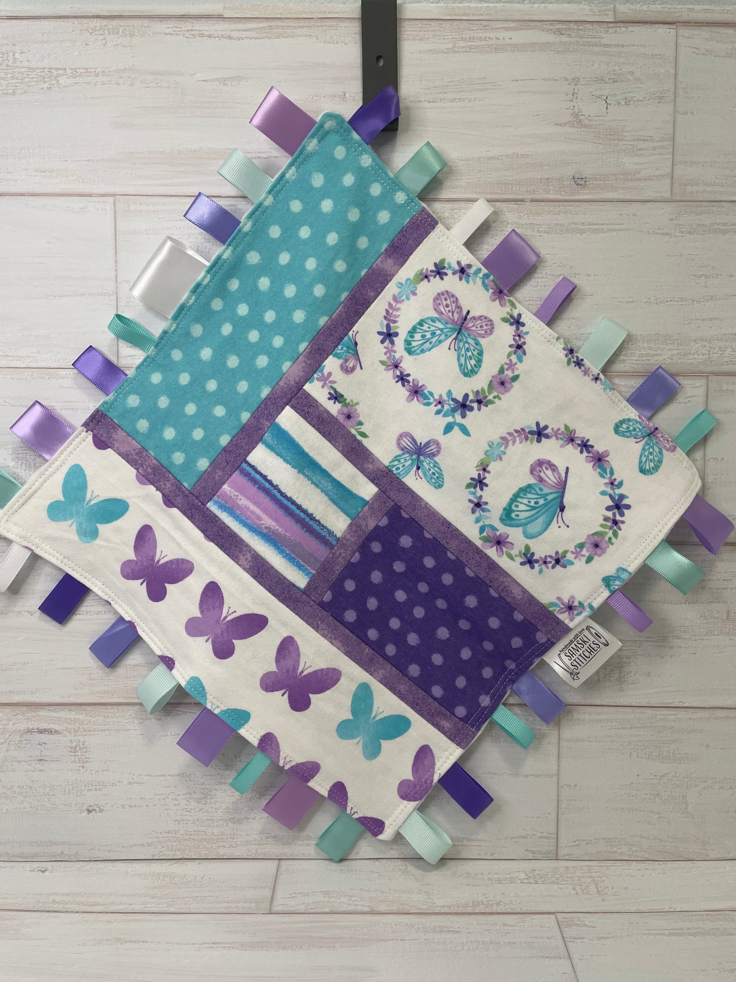 Butterflies on White with Turquoise and Purple Accents Sensory Taglet