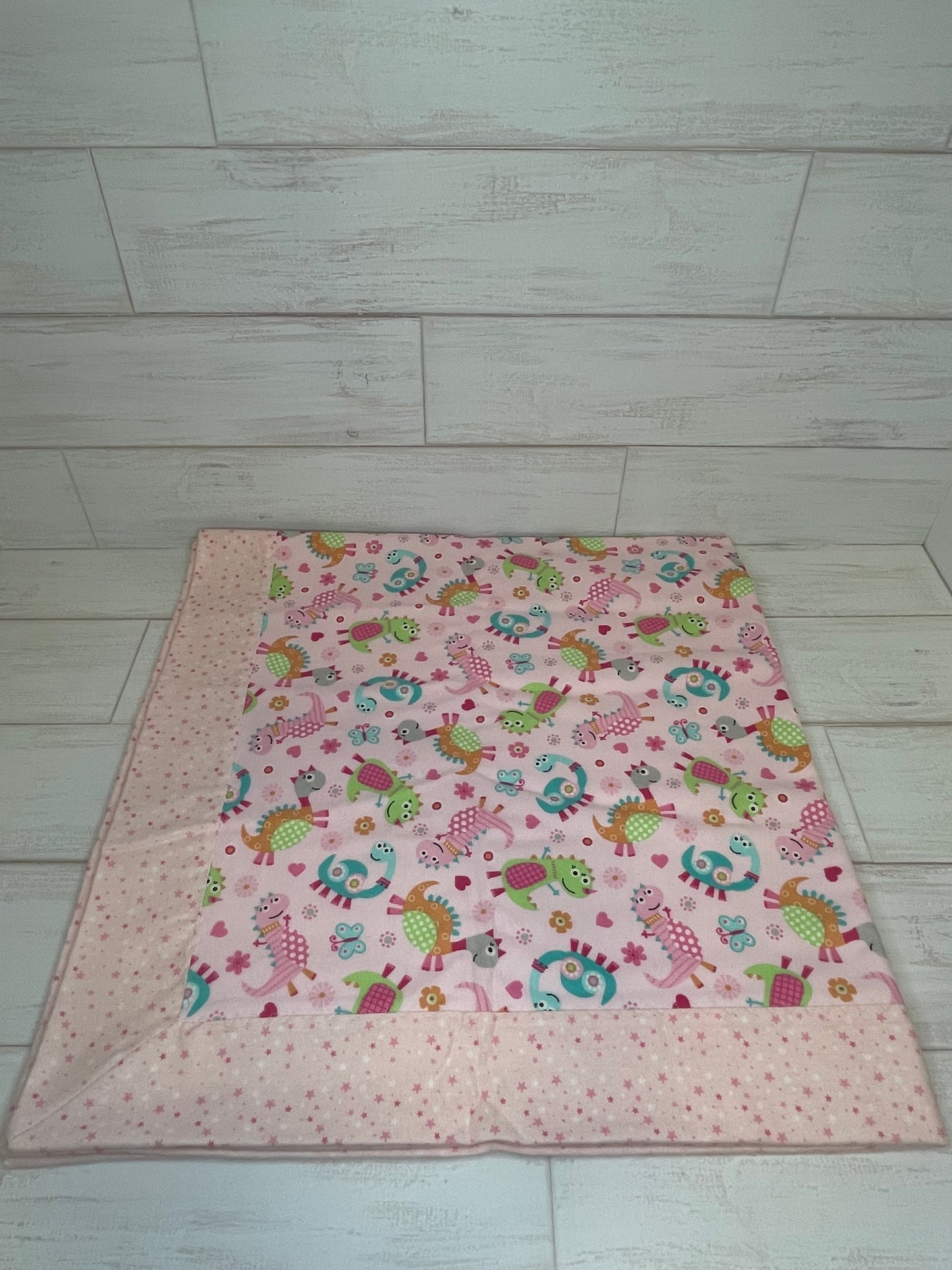 Dinosaurs on Pink with Stars Swaddle Blanket